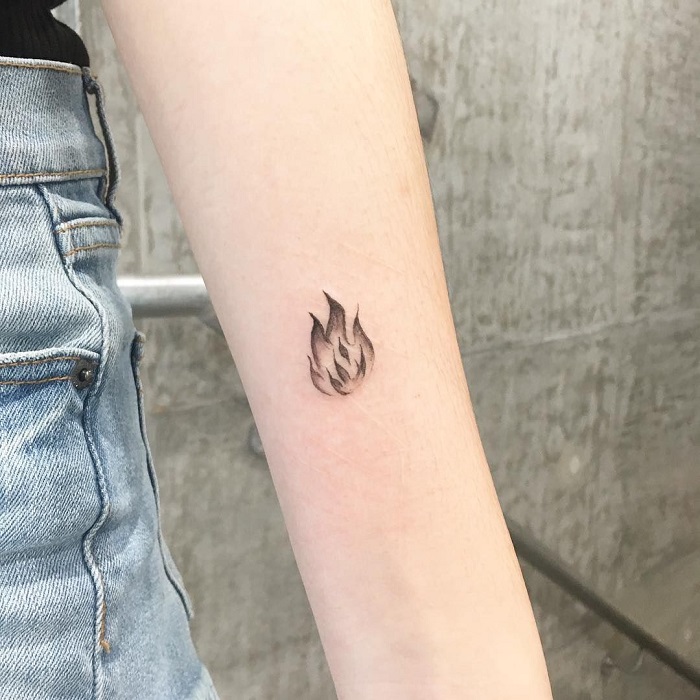 Minimalist fire tattoo behind the ear