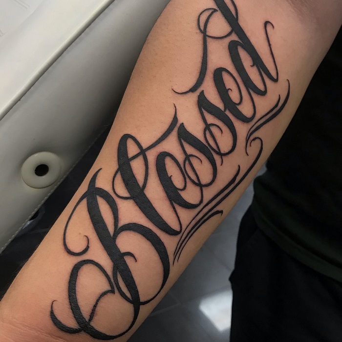 Black shaded simple blessed tattoo on full forearm for men