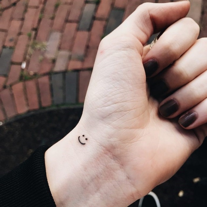 A hand with a smiley face tattoo on it photo  Free Grey Image on Unsplash