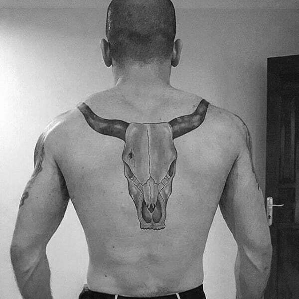 Black and grey bull skull tattoo located on the back